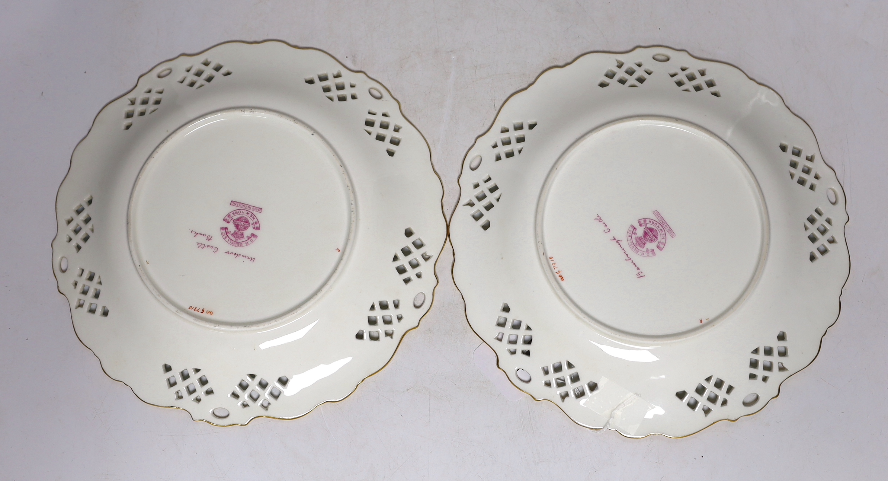 A pair of Mintons bone china dishes, with painted central cartouches of Windsor and Bamborough Castles, 22.5cm diameter
